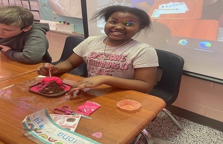 Student working on a valentines volcano.